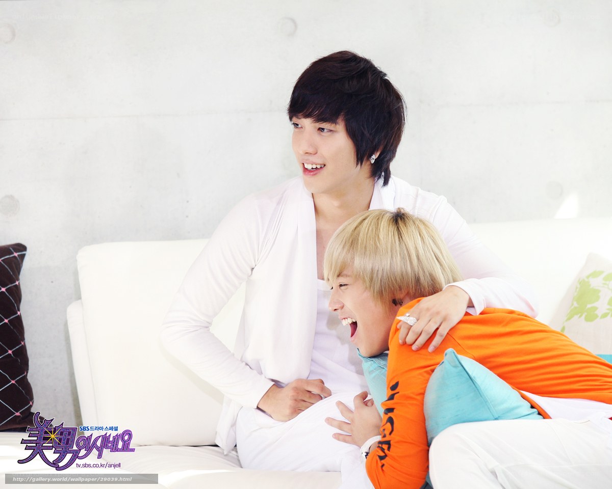 two men laughing on a couch