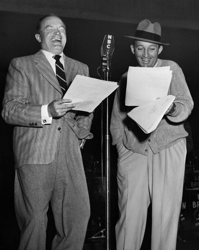 Two men laughing with scripts