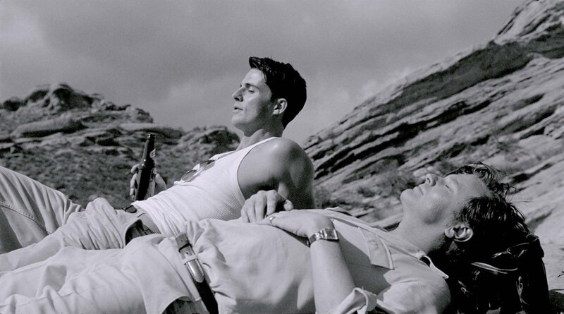 Two Men Lying on Rocks