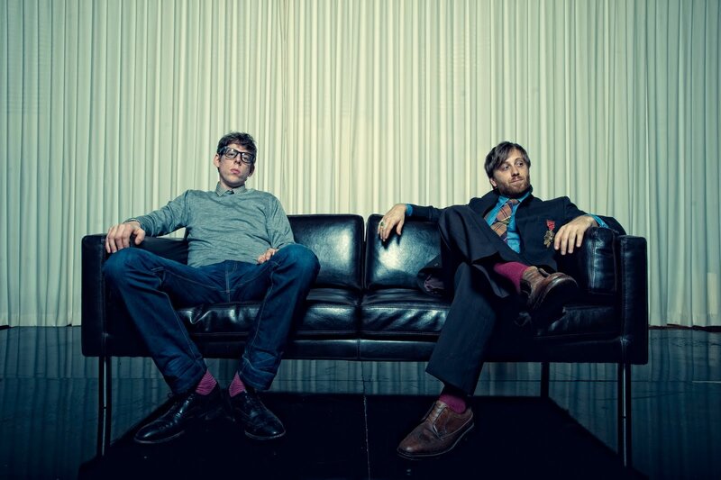 Two men on a black couch
