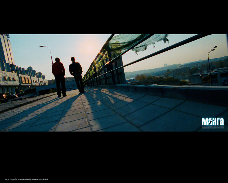 Two men on a bridge at sunset