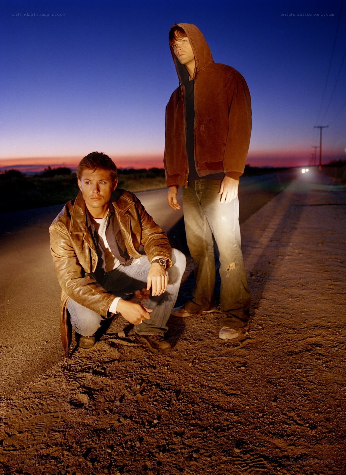 two men on a road at dusk