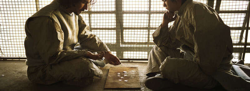 Two men playing a game in prison