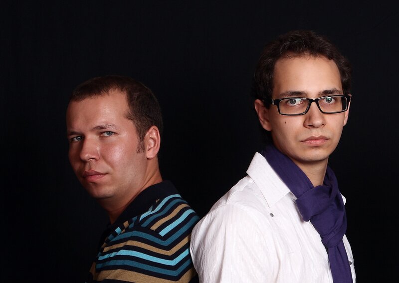 two men posing back to back