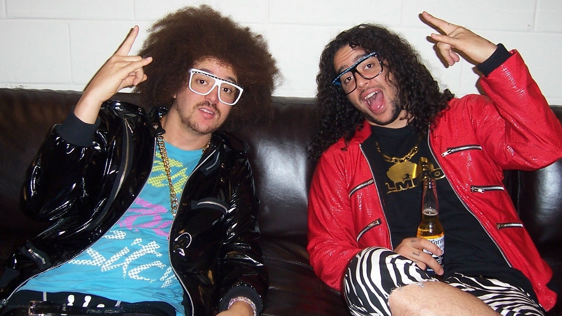 Two men posing on a couch