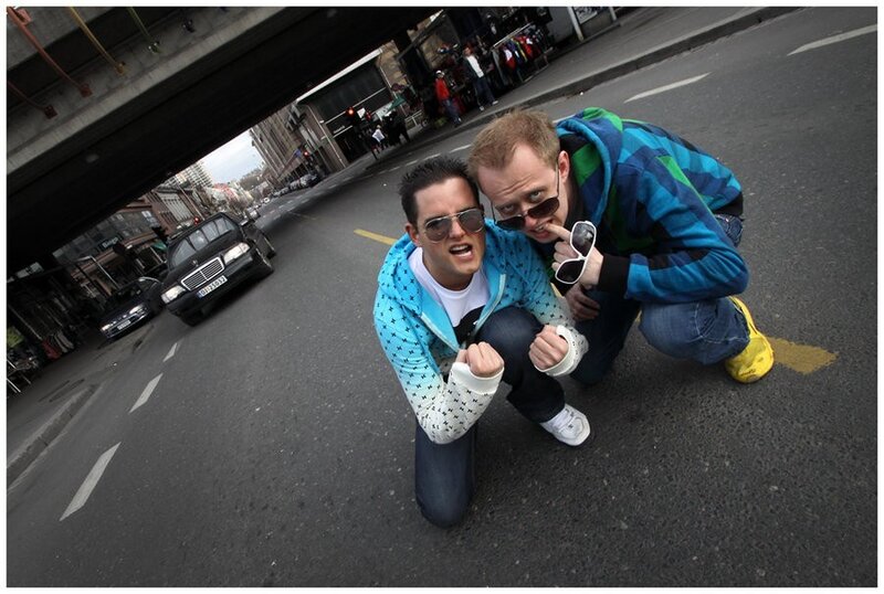 Two Men Posing on Street — Blue