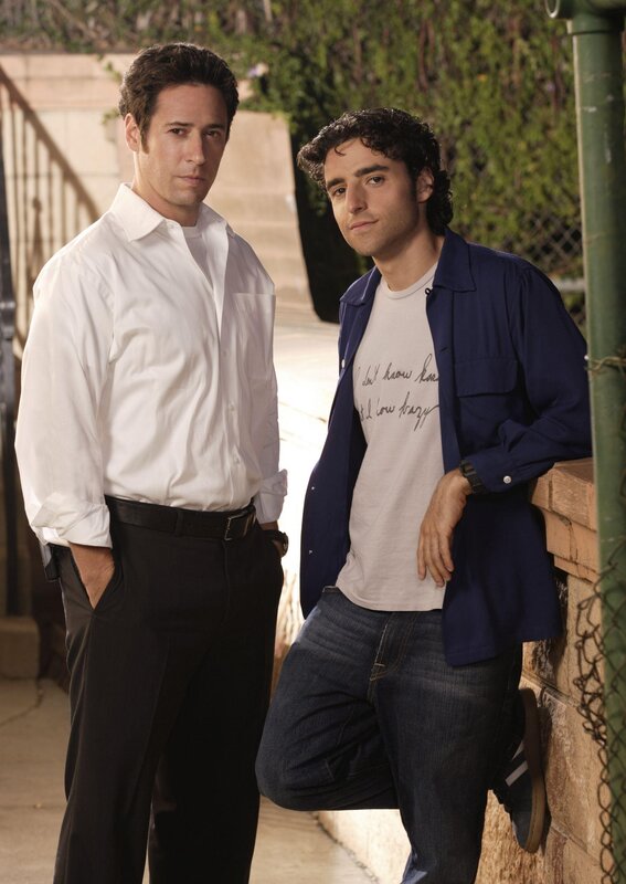Two men posing outdoors