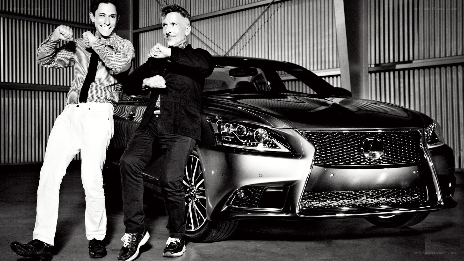 Two men posing with a luxury car
