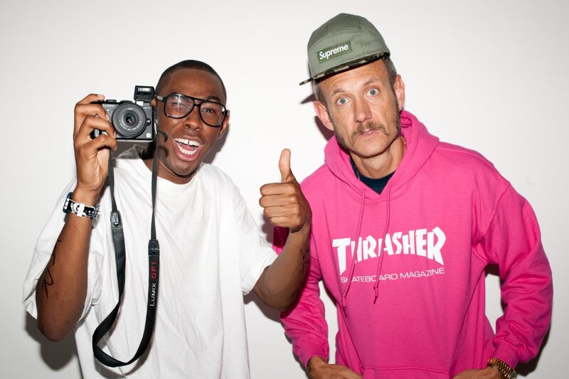 Two men posing with camera