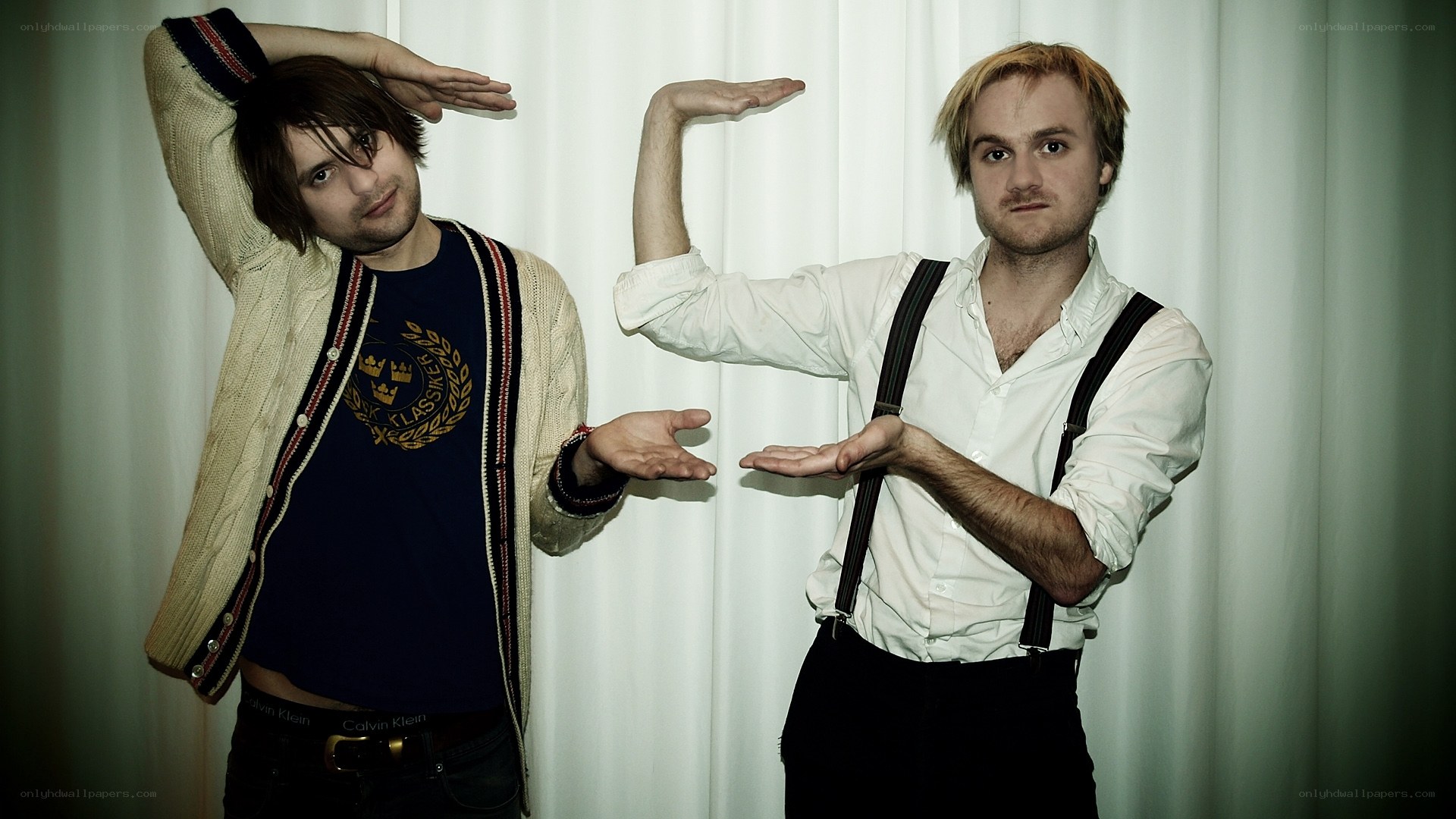 Two men posing with hands