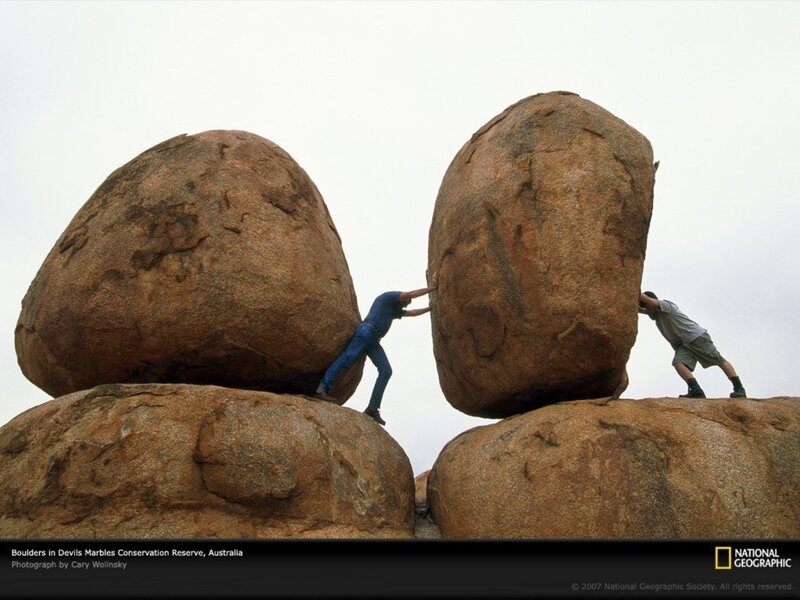 Two Men Pushing Boulders