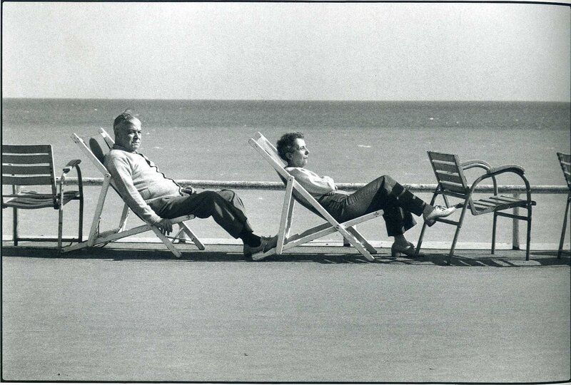 Two men relaxing on beach chairs