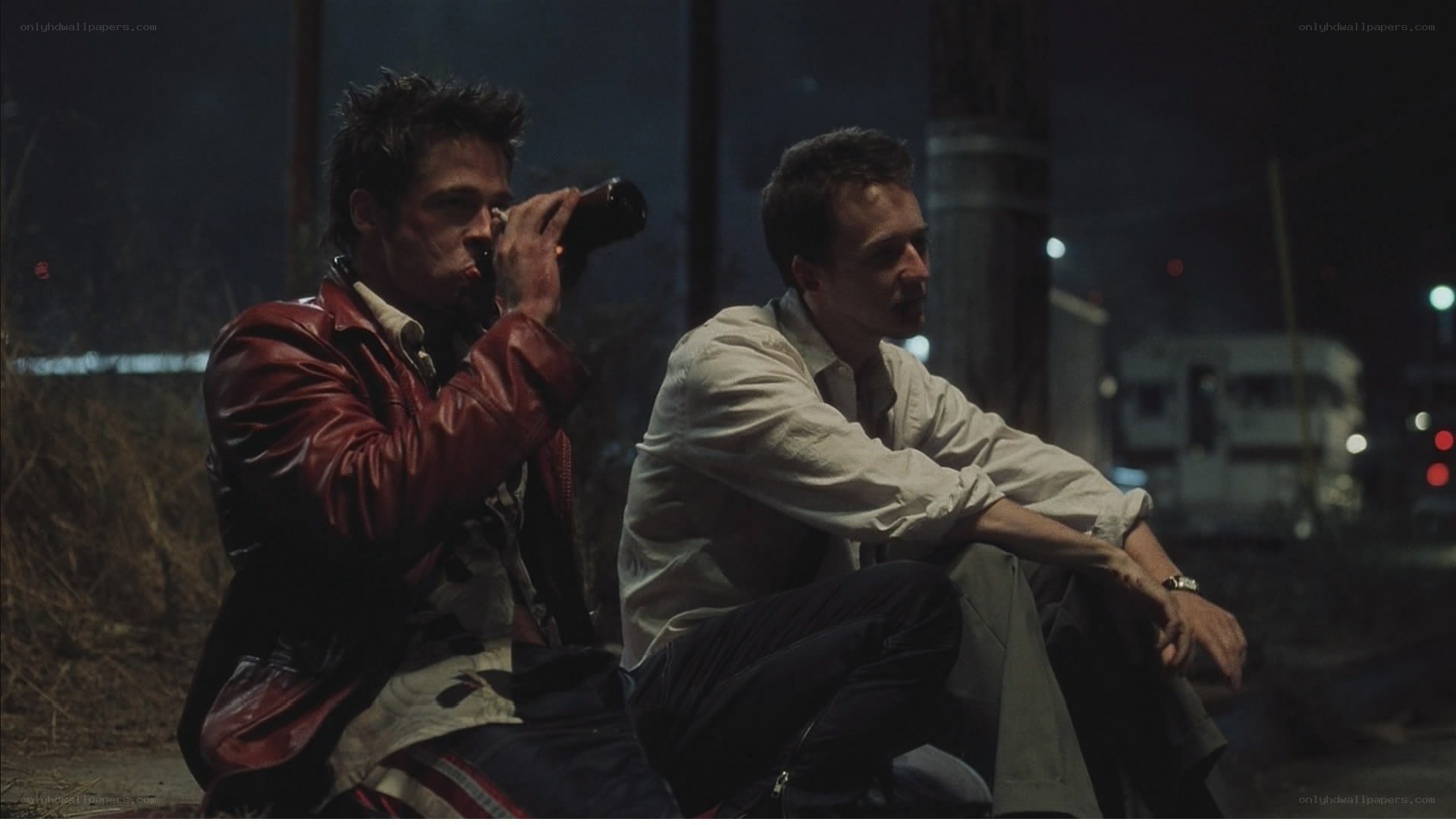 two men sitting at night