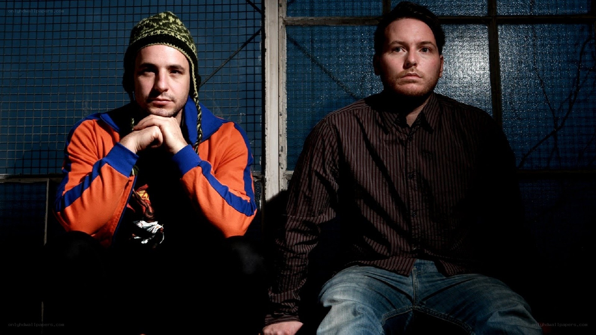two men sitting in front of a window