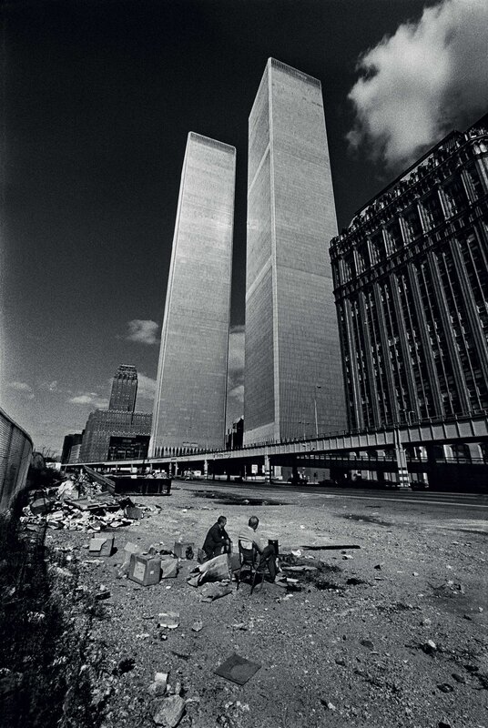 Two Men Sitting Near Towers