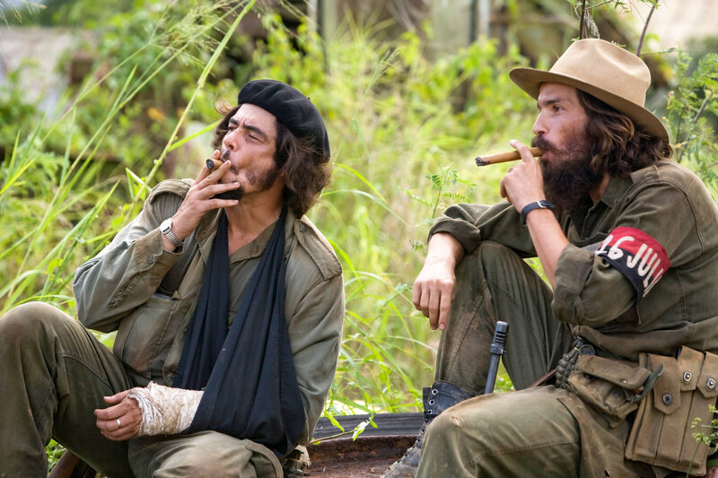 Two men smoking cigars in military gear