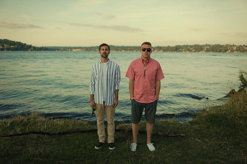 Two Men Standing by Water