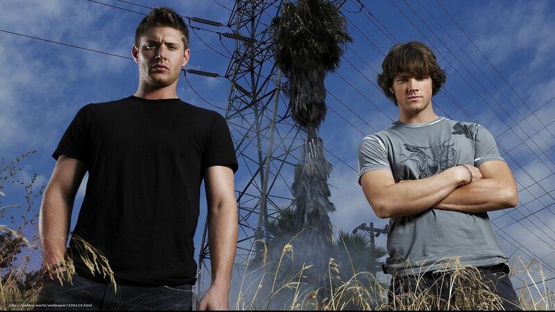 two men standing in field