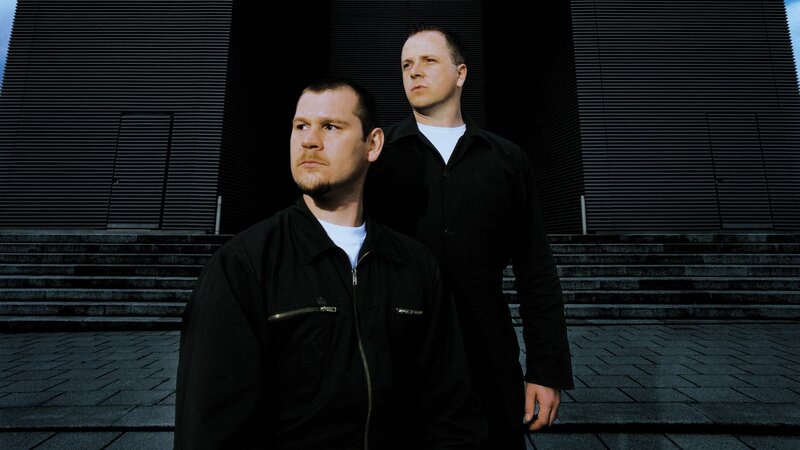 two men standing outside