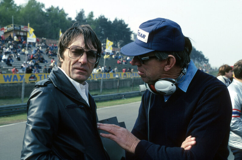 Two men talking at a race track