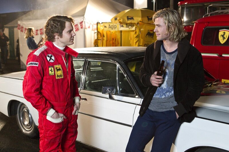 Two men talking by a car