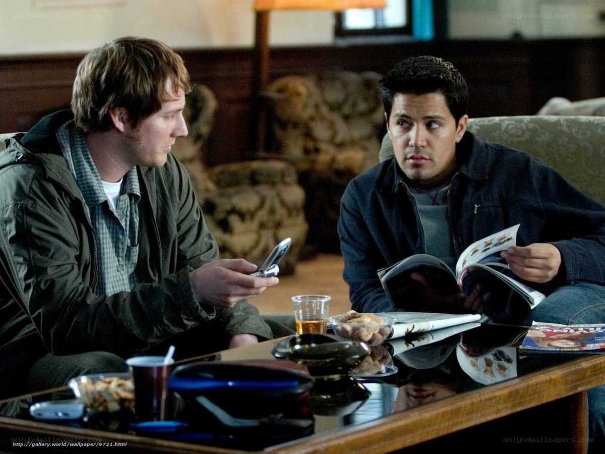 two men talking in living room
