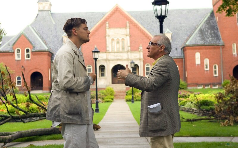 Two men talking on a campus