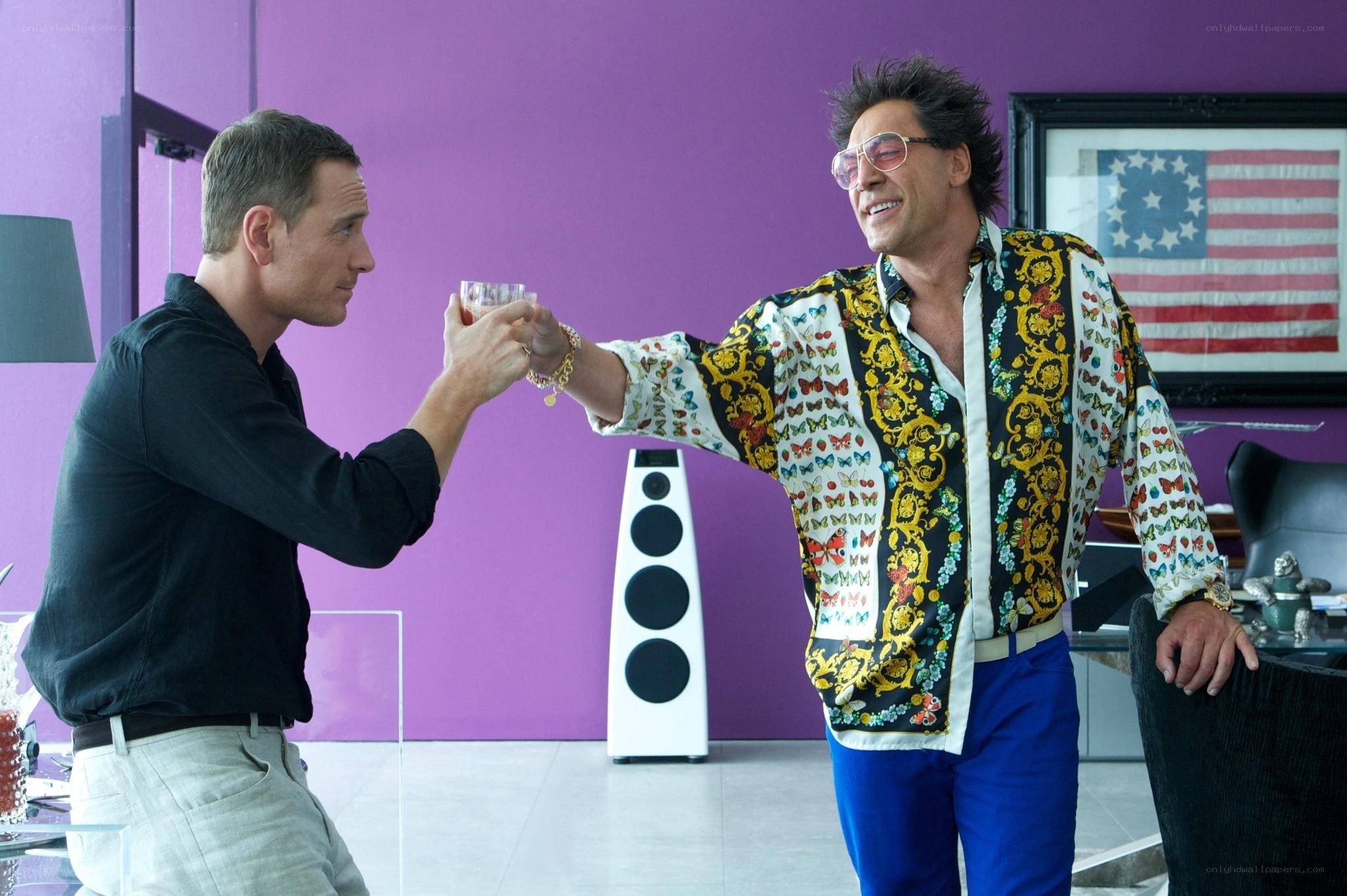 Two men toasting in a colorful room