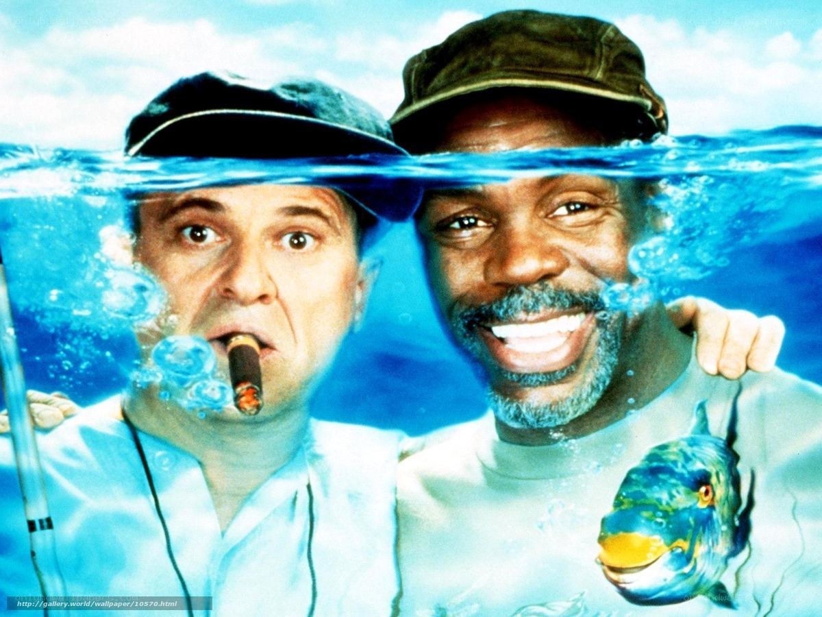 Two men underwater with fish