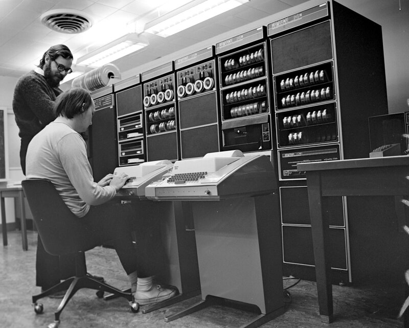 Two men using a mainframe computer