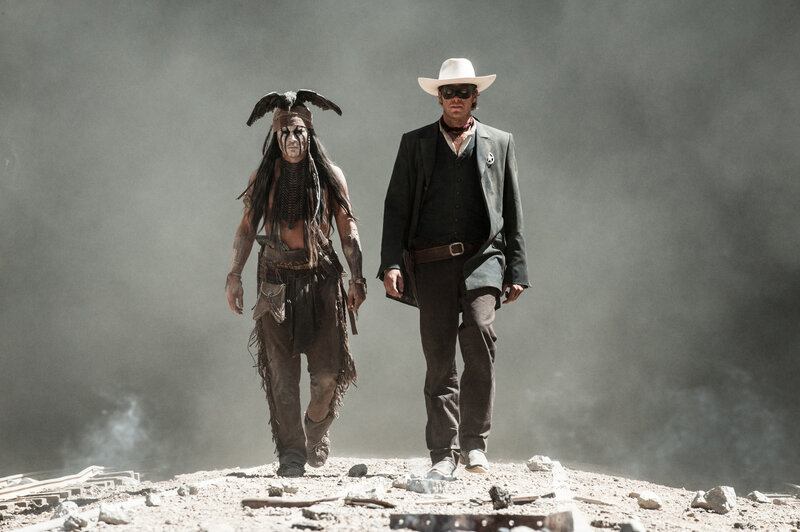 two men walk through smoke