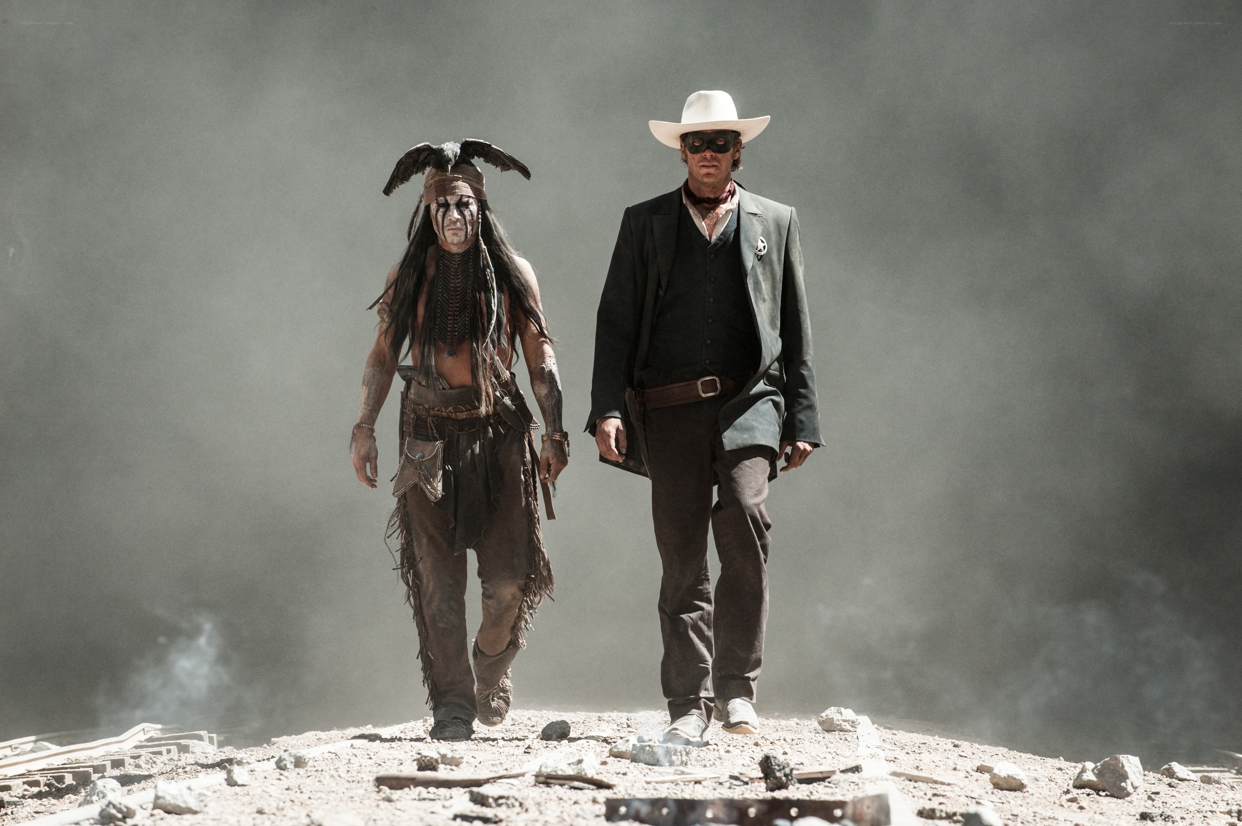 two men walk through smoke