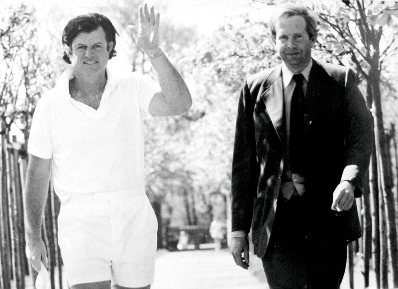 Two men walking in a park