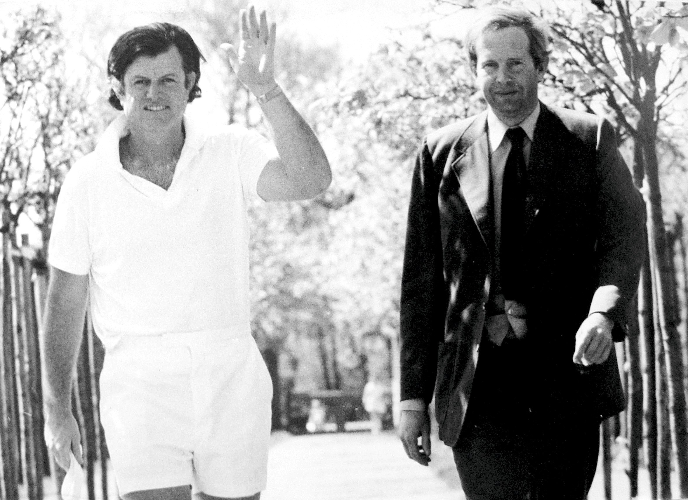 Two men walking in a park