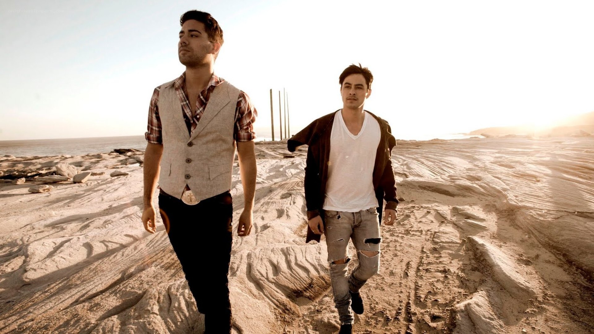 Two men walking on a beach