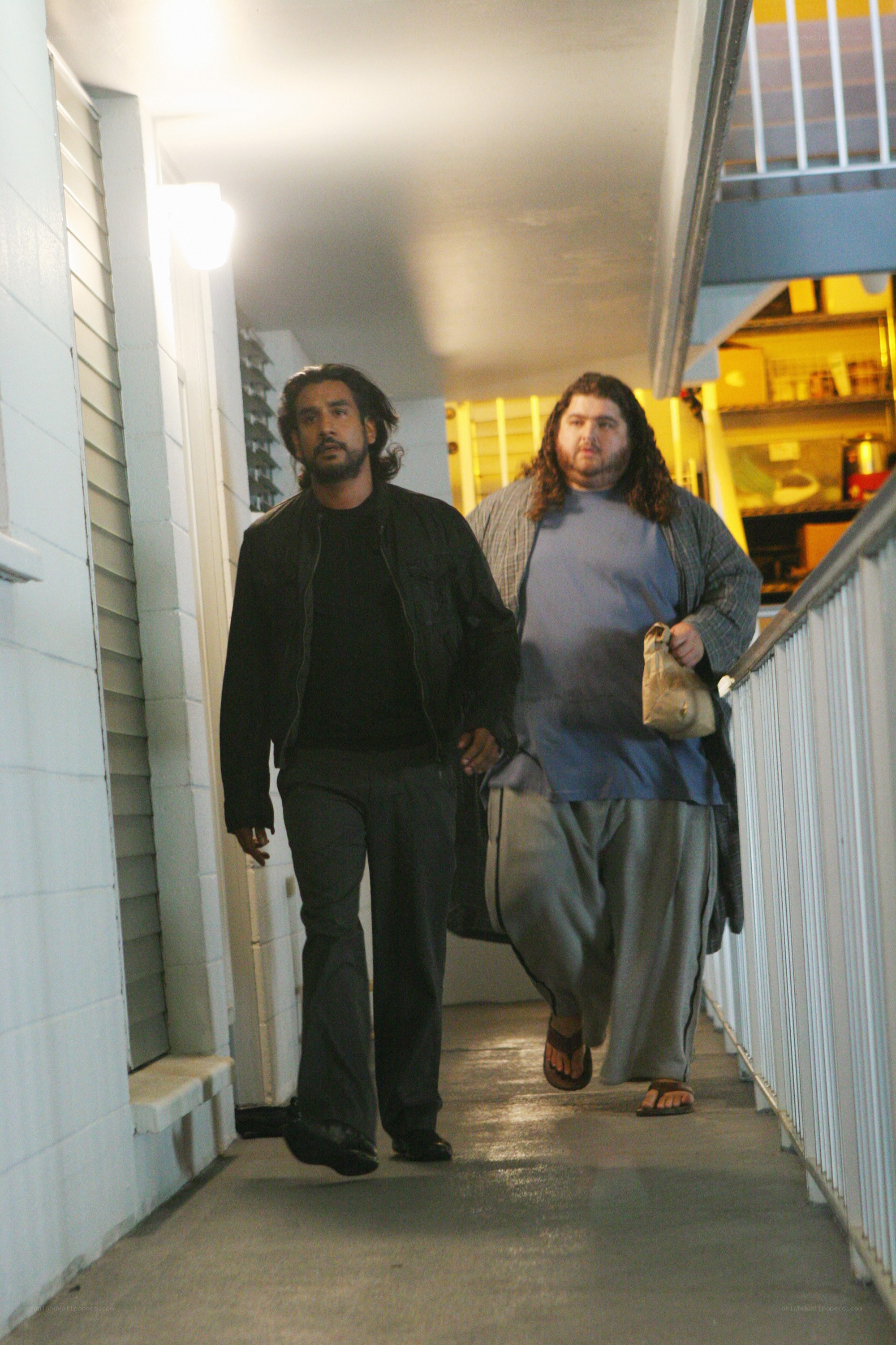 two men walking on a corridor