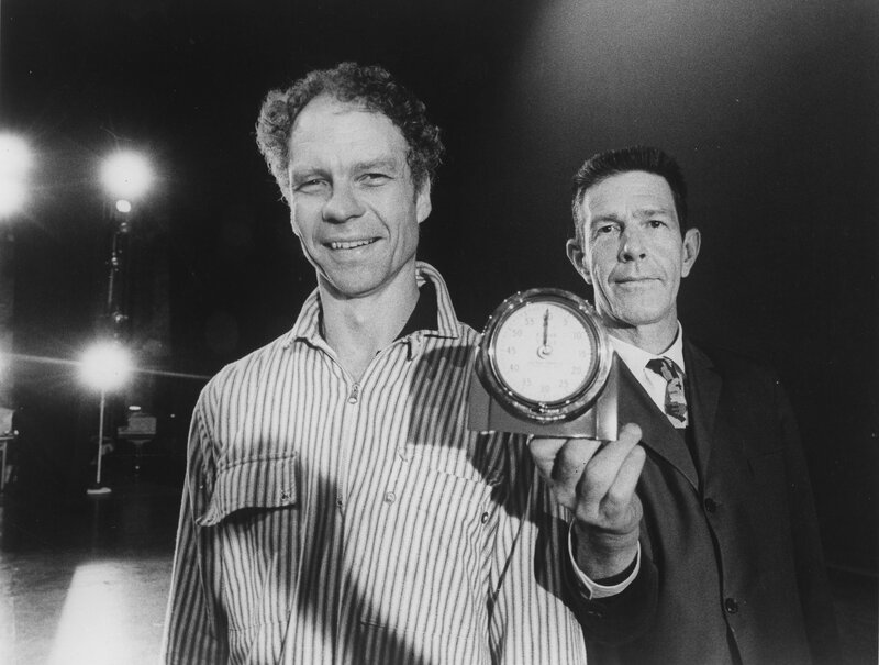 Two men with a clock