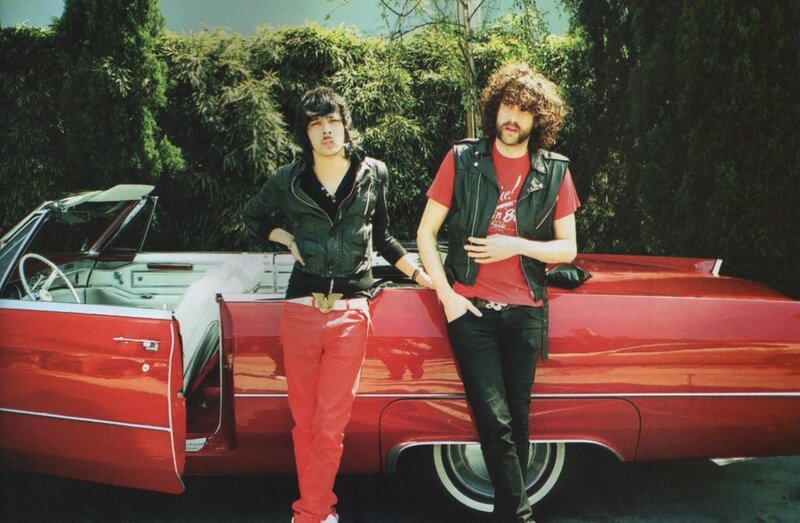 Two men with a red car