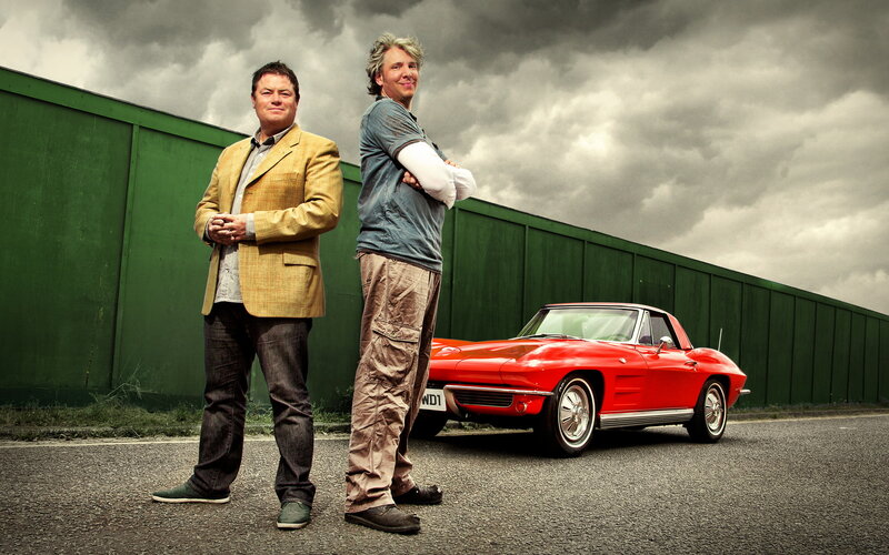 Two men with a red car