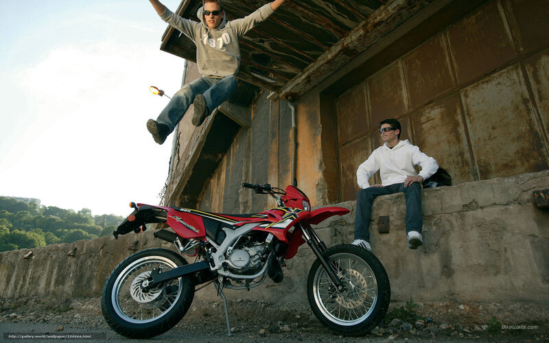 Two men with a red motorcycle