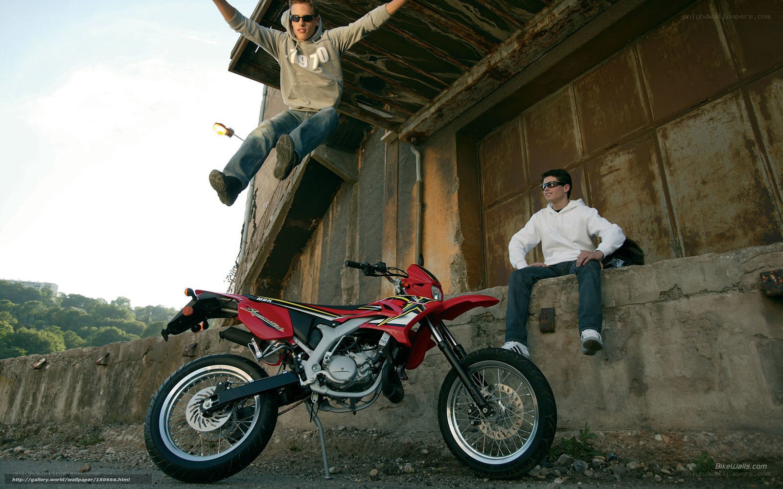 Two men with a red motorcycle