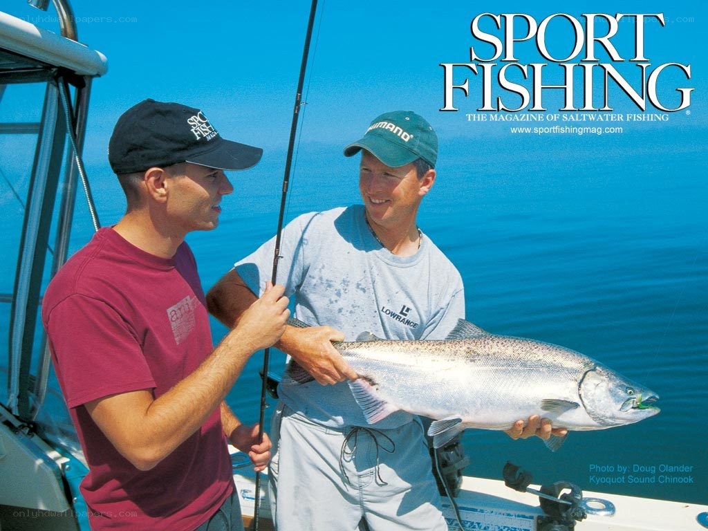 Two men with a salmon on a boat