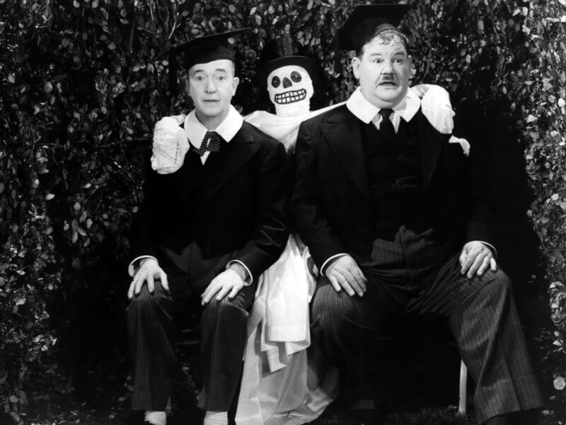 Two men with a skeleton prop