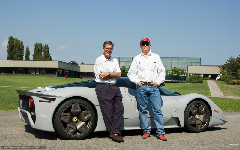 Two men with a sports car