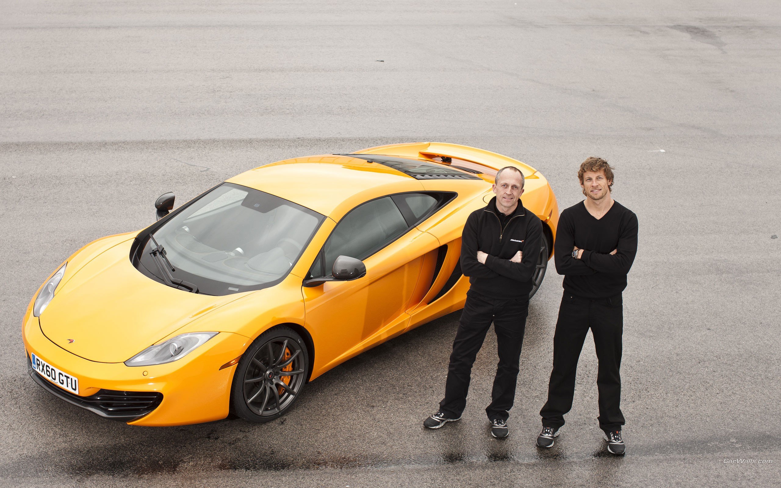 Two men with a yellow McLaren