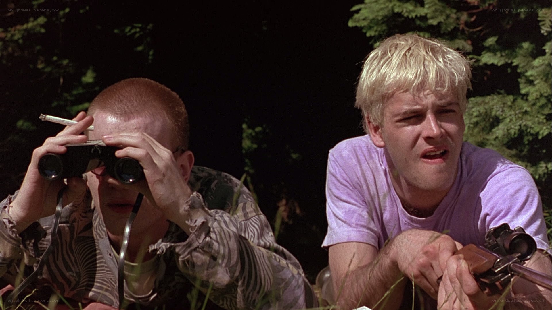 Two men with binoculars and rifle