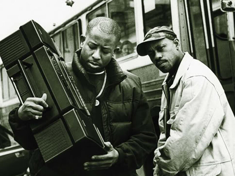 Two men with boombox on street