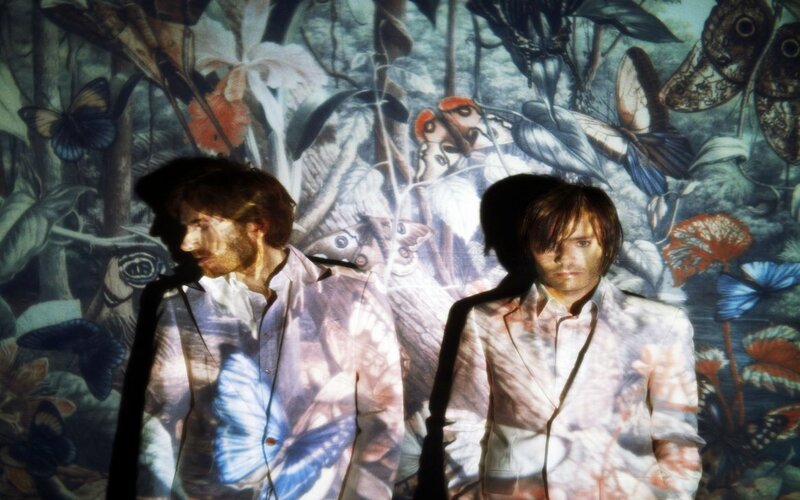 Two men with butterfly projection