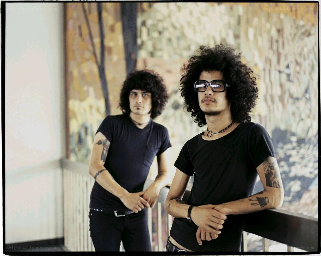 two men with curly hair posing