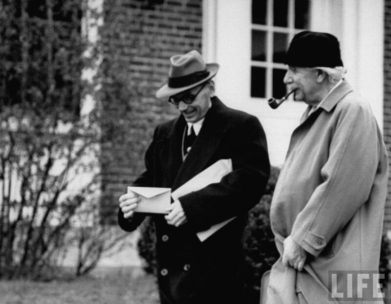 Two men with documents outside